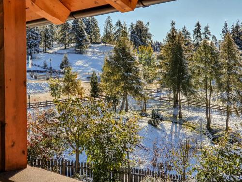 a winter view from the porch of a cabin at Berghotel zum Zirm in Collalbo