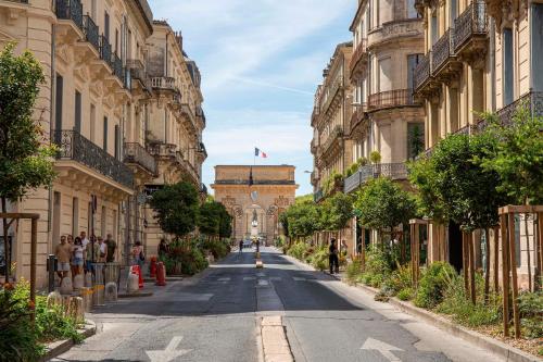 an empty street in a city with buildings at Grand Hôtel du Midi Montpellier - Opéra Comédie in Montpellier