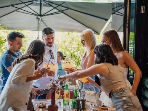 a group of people standing around a table with drinks at Mercure Timisoara in Timişoara
