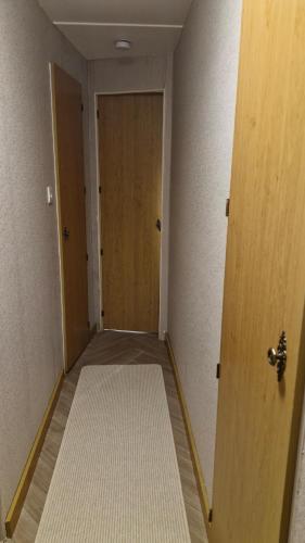 an empty hallway with a door and a floor at Static Caravan situated at Wigbay, Stranraer in Stranraer
