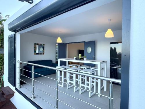 a view of a balcony with a bar and chairs at Villa Le Grand Bleu in Le Moule