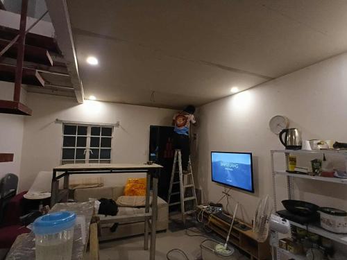 a living room with a wall with a tv in it at Tsinoy Villa in Pandi