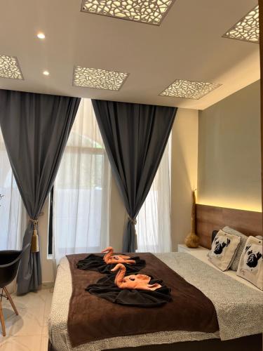 a bedroom with a large bed with black curtains at Casa Luna beach side Luxurious comfy apt in center Paphos in Paphos