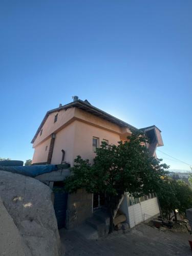 a building with a tree in front of it at Kesen Cappadocia House in Urgup