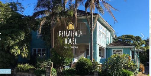 a sign in front of a blue house at Keiraleagh House in Wollongong