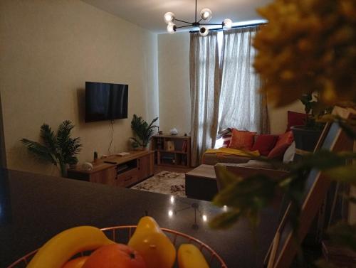 a living room with a couch and a table with fruit at 2 Bed Inside Tilisi 