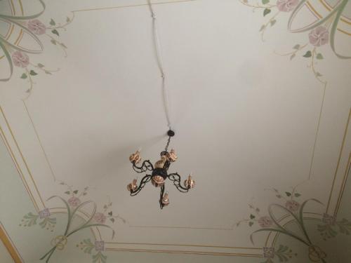a chandelier hanging from a ceiling in a room at Hotel Sant'Anna in Floresta