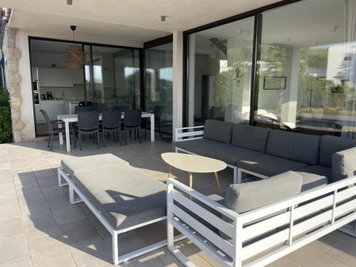 a patio with a couch and a table and chairs at Trebol in Sa Pobla