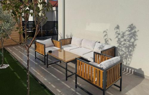 a patio with two couches and a table and chairs at Cozy Home In Privlaka With Wifi in Glavan
