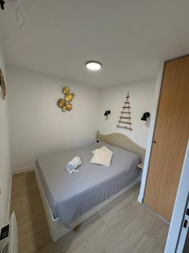 a bedroom with a bed and a christmas tree on the wall at Appt 4 pers, pied des pistes in Flumet