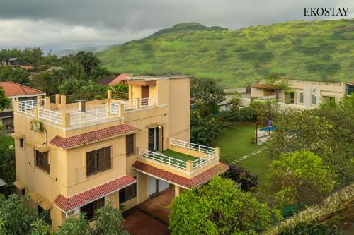 an aerial view of a building with a yard at Ekostay Gold - Olive Crest Villa - Spacious Lawn in Lonavala