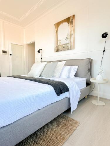 a bedroom with a large bed with a mirror on the wall at CBD Studio - Sleeps 4 - Rooftop Courtyard - Views in Wollongong