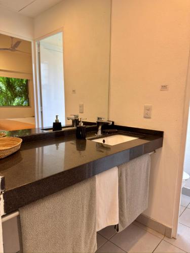 a bathroom counter with a sink and a mirror at Papaya Condo Acapulco Diamante -Solo Adultos in Acapulco