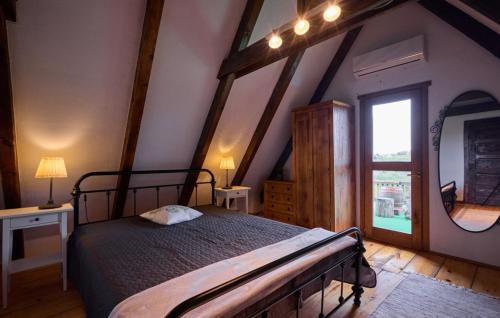 a bedroom with a bed and a large window at Holiday Home Trnovka by Villas Guide in Veliko Brdo