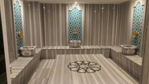 a room with three bowls on the floor and a table at CPAnkara Hotel in Ankara