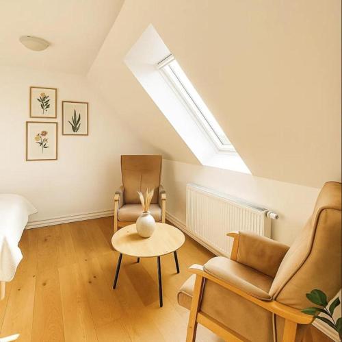 a living room with two chairs and a table at Aarhus Stay Apartments in Hasselager