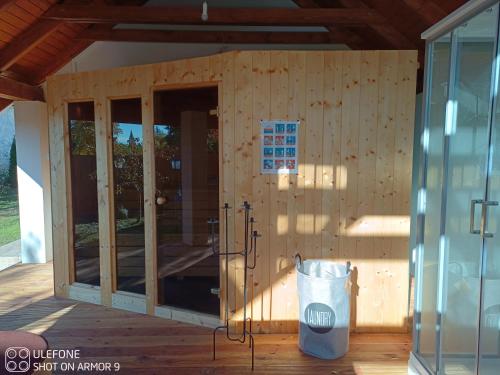 a wooden house with glass doors and a trash can at Tokaj-Wine Guesthouse and Spa in Mád
