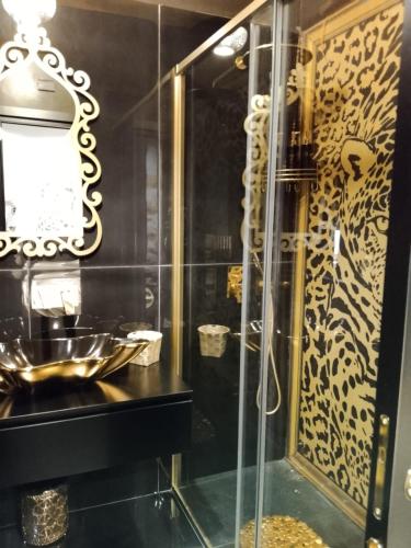 a bathroom with a glass shower and a sink at SAHARA chic in Reggio di Calabria