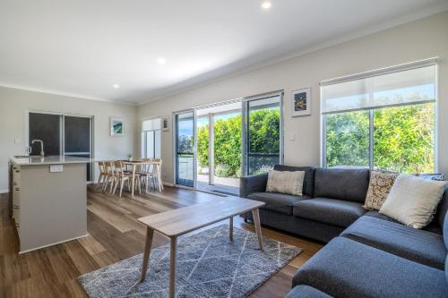 a living room with a couch and a table at Albany Bayside by the BnB Collection in Albany