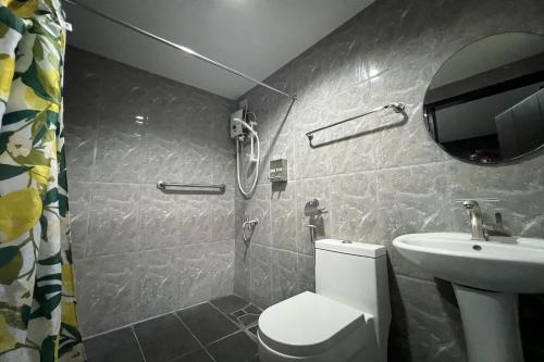 a bathroom with a toilet and a sink at Palm Cabanas Resort in Arayat