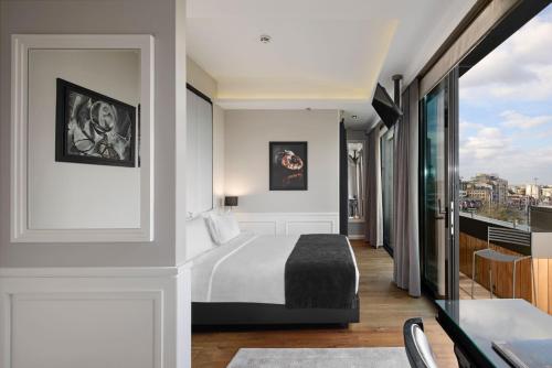 a hotel room with a bed and a balcony at Gezi Hotel Bosphorus, Istanbul, a Member of Design Hotels in Istanbul