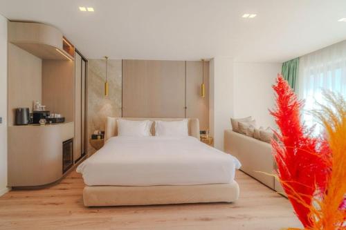 a bedroom with a white bed and a large window at Eternity Athens in Athens