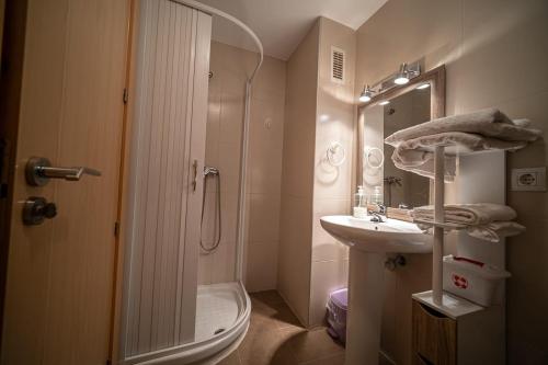 a bathroom with a shower and a toilet and a sink at Las torres 1 in Calatayud