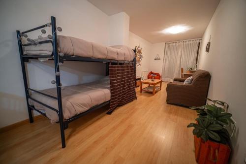 a room with two bunk beds and a couch at Las torres 1 in Calatayud
