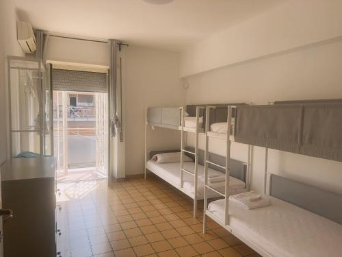 a room with two bunk beds and a window at Lisa HOUSE in Rome