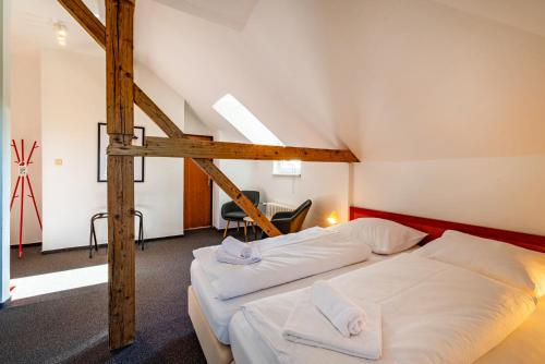 two beds in a room with a loft at B&B Villa Hotel in Mariánské Lázně