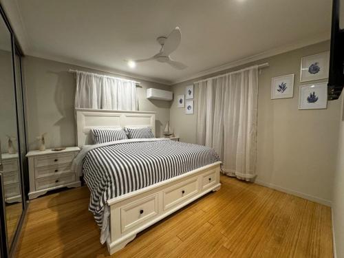 a bedroom with a bed with a black and white comforter at Scarborough Stays - Sleeps 8 by the Beachside in Scarborough