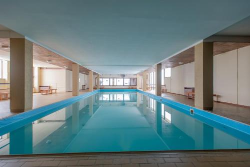 a large swimming pool in a building at Top Apartments in Passo del Tonale