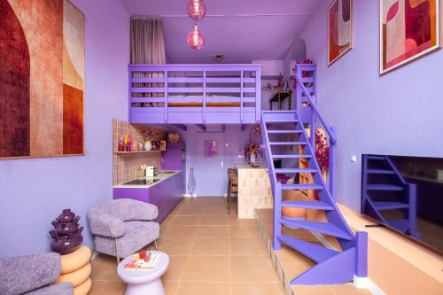 a room with a blue bunk bed and a staircase at Lila-Licious in Breda