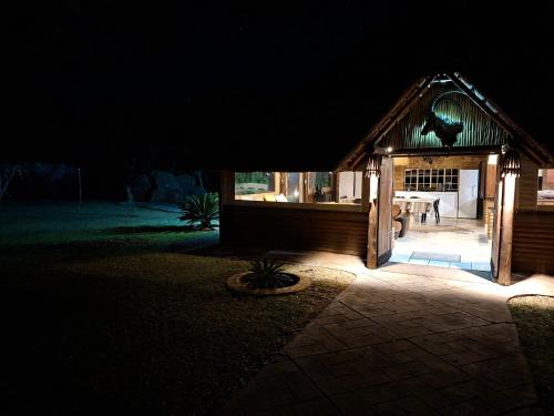 a small building with lights in the dark at Zomoya Game Farm in Vaalwater