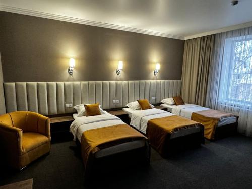 Ένα ή περισσότερα κρεβάτια σε δωμάτιο στο Гостиница БУРСА