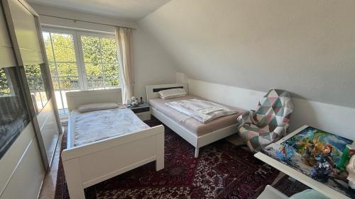 a small room with a bed and a chair at House in Laatzen! contactless check-in in Hannover