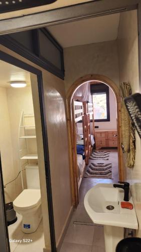 a small bathroom with a toilet and a sink at Rock Surf Hostel Taghazout in Taghazout