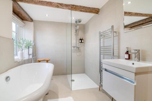 a bathroom with a white tub and a sink at 5 Bed in Cleeve oc-t33614 in Brockley