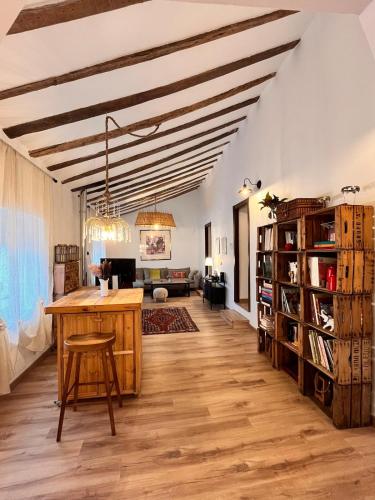 a living room with a wooden table and a couch at Casa Campo 10 min de Puy de Fou in Guadamur