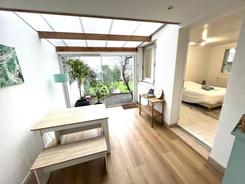 a room with a view of a bedroom and a bed at Appartement cosy avec jardin - Stationnement gratuit in Limoges