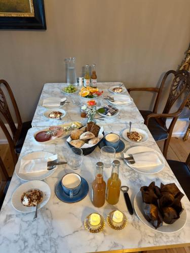 a long table with plates of food on it at Risinge Herregård in Ullerslev