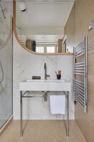 a bathroom with a sink and a mirror at Amiral-Fondary in Paris
