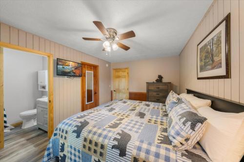 a bedroom with a bed and a ceiling fan at On Dolly Time Slow Down and Stay Awhile in Pigeon Forge