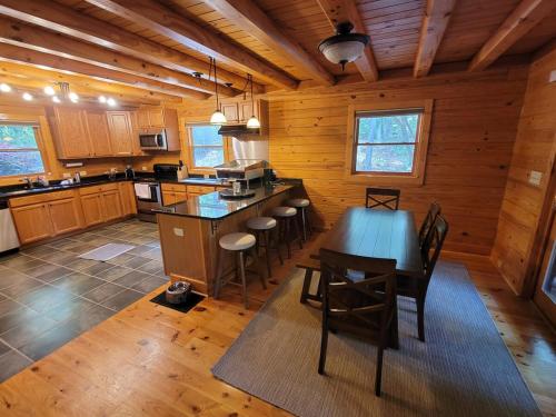 a kitchen with a table and chairs in a cabin at Wilderness retreat in Marion