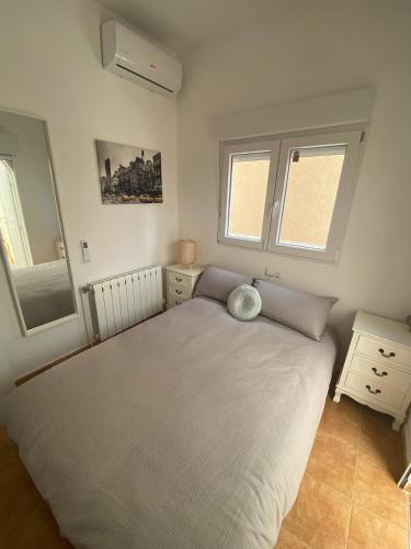 a bedroom with a large bed and two windows at Casa iris in San Miguel de Salinas