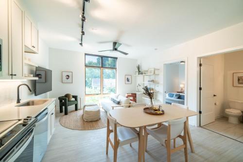 a kitchen and living room with a table and a dining room at Inkwell Charlotte in Charlotte