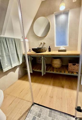 a bathroom with a sink and a mirror at Black Pine Cabin in Szentendre