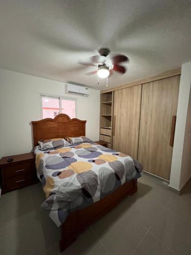 a bedroom with a bed and a ceiling fan at Paradise away from home in Punta Cana