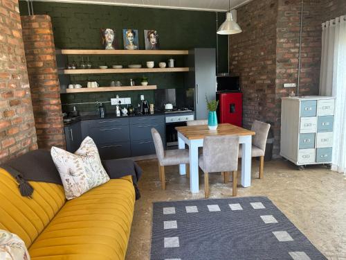 a living room with a couch and a table at Cottage on Salvia in East London