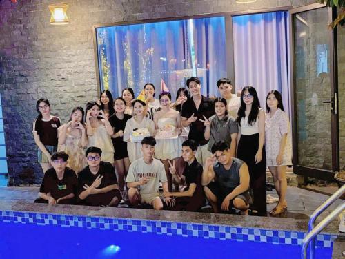 a group of people standing next to a swimming pool at Trang An Hana homestay in Nguyên Ngoại